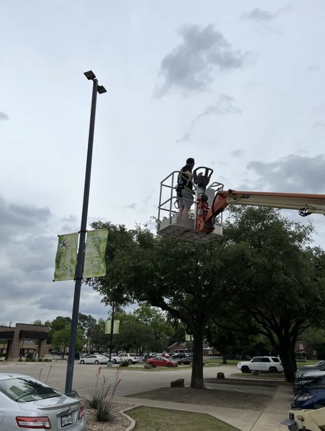 A&M Electrical bucket truck servicing a parking lot light pole
