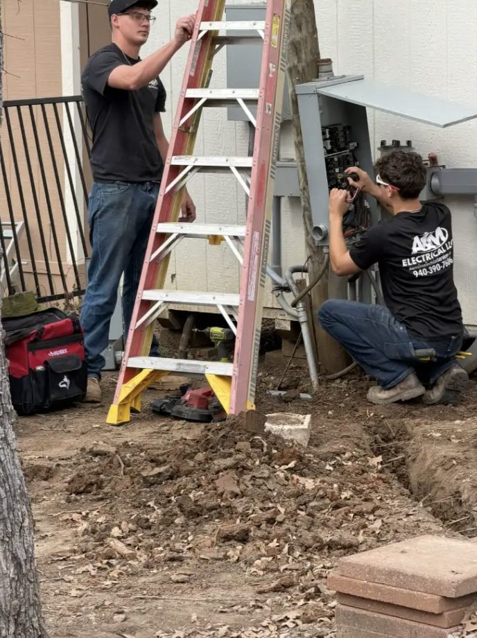 A&M Electrical technicians servicing an outdoor electrical panel and meter