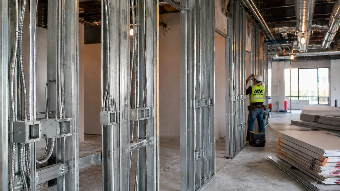 A&M Electrical crew member wiring a commercial tenant build-out