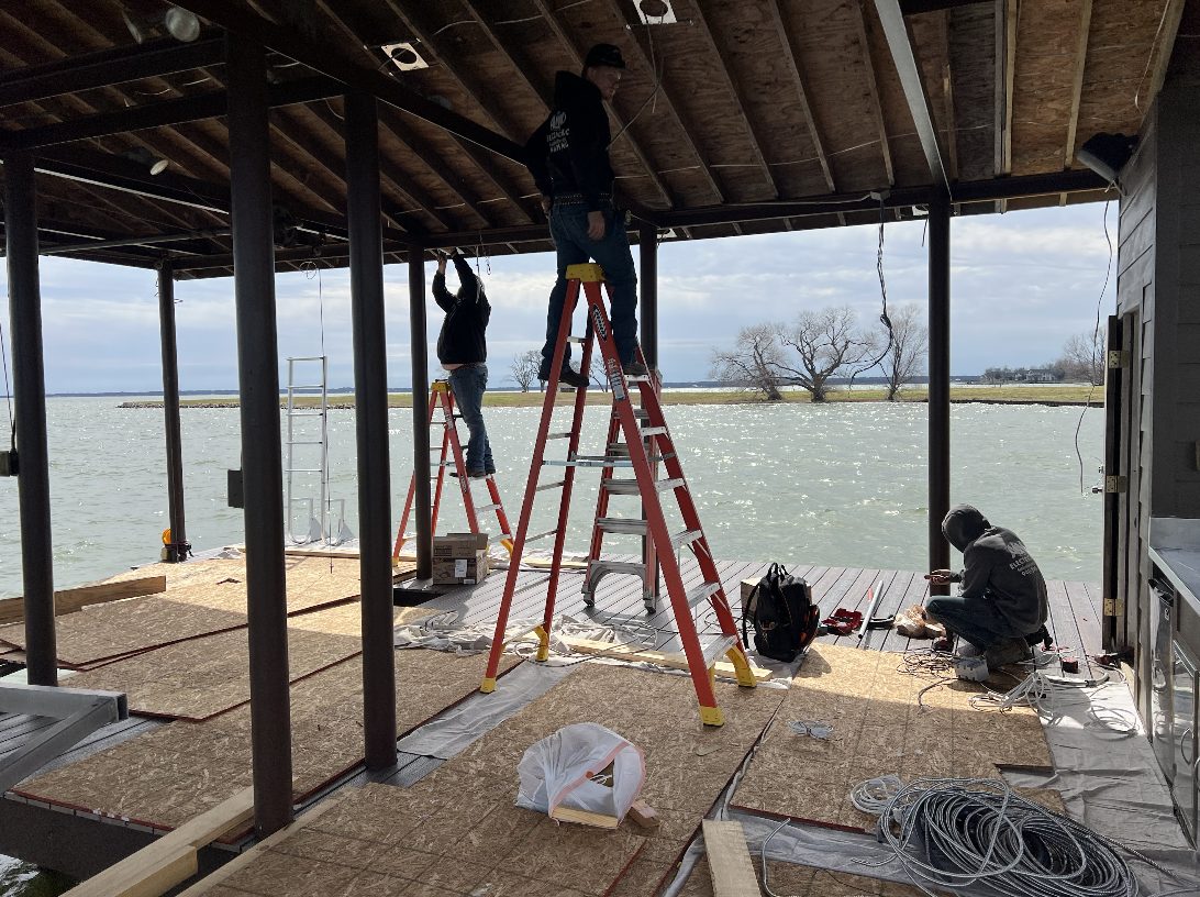 A&M Electrical crew wiring a lakeside boat dock